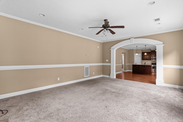 436 Sebastian Dr, Grovetown, GA 30813 - unfurnished living room featuring dark colored carpet, arched walkways, ceiling fan, decorative columns, and ornamental molding