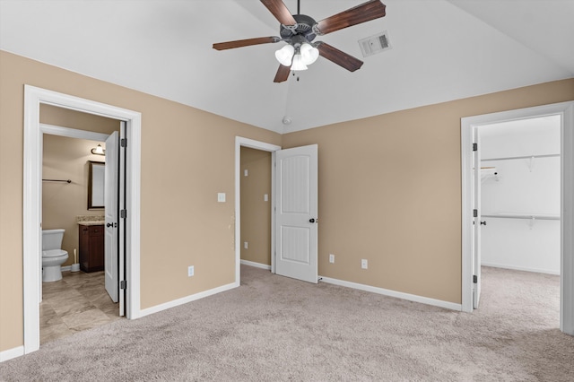 436 Sebastian Dr, Grovetown, GA 30813 - unfurnished bedroom with light colored carpet, a spacious closet, connected bathroom, a ceiling fan, and vaulted ceiling