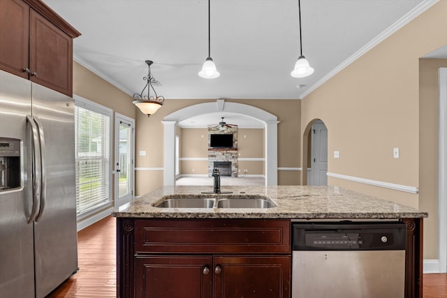 436 Sebastian Dr, Grovetown, GA 30813 - kitchen with appliances with stainless steel finishes, ceiling fan, a stone fireplace, crown molding, and arched walkways