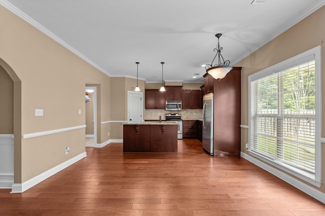 436 Sebastian Dr, Grovetown, GA 30813 - kitchen with stainless steel appliances, arched walkways, tasteful backsplash, an island with sink, and hardwood / wood-style floors