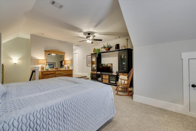 bedroom featuring light carpet, visible vents, baseboards, and vaulted ceiling