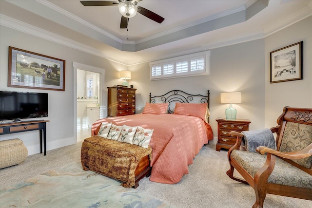 bedroom featuring a raised ceiling, connected bathroom, carpet, and ornamental molding