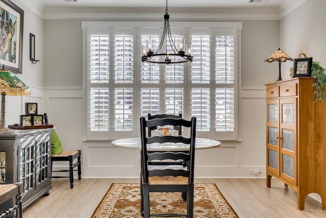 dining area featuring plenty of natural light, a chandelier, and a decorative wall