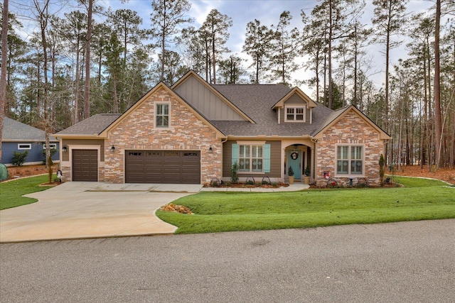 craftsman inspired home featuring roof with shingles, a front lawn, concrete driveway, a garage, and stone siding