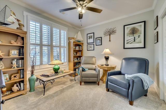 sitting room featuring visible vents, ceiling fan, crown molding, and carpet