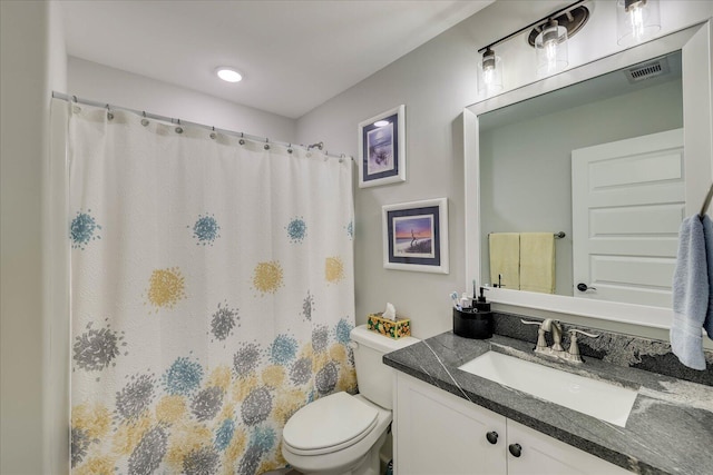 bathroom with visible vents, toilet, vanity, and a shower with curtain