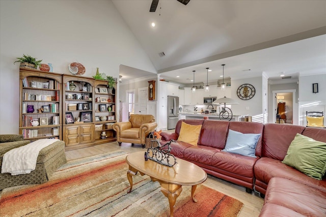 living room featuring visible vents, light wood-style flooring, high vaulted ceiling, and ornamental molding