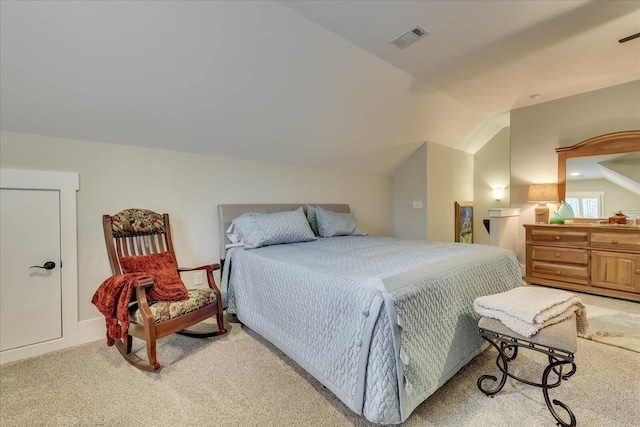 bedroom featuring vaulted ceiling, visible vents, and light carpet