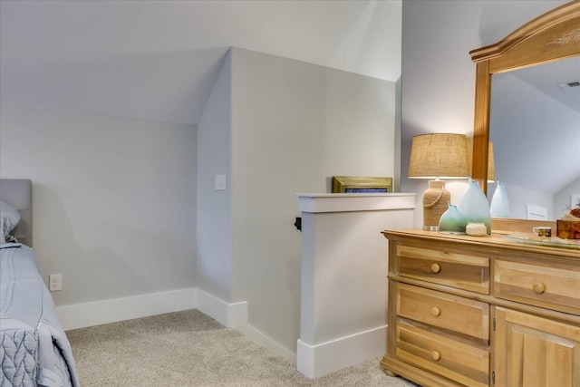 bedroom with vaulted ceiling, visible vents, baseboards, and light carpet