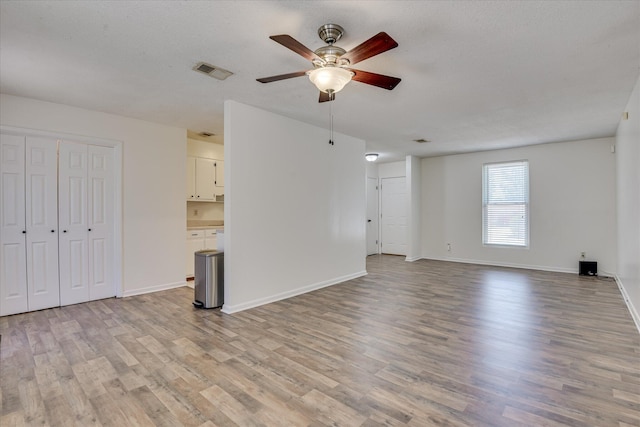 3647 N Madrid Dr, Augusta, GA 30906 - unfurnished living room with a ceiling fan, light wood finished floors, and baseboards