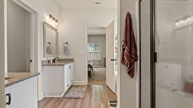 4756 Storey Mill Rd, Hephzibah, GA 30815 - full bath with wood finished floors, connected bathroom, vanity, and a shower stall