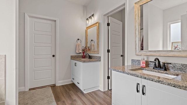 4756 Storey Mill Rd, Hephzibah, GA 30815 - bathroom featuring wood finished floors, two vanities, and baseboards