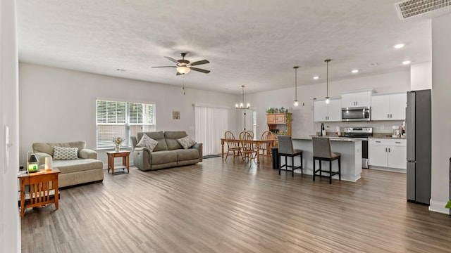 4756 Storey Mill Rd, Hephzibah, GA 30815 - living area featuring ceiling fan, recessed lighting, wood finished floors, a textured ceiling, and a chandelier