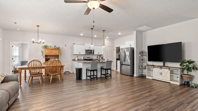 4756 Storey Mill Rd, Hephzibah, GA 30815 - living room with light wood finished floors, ceiling fan, a chandelier, and recessed lighting