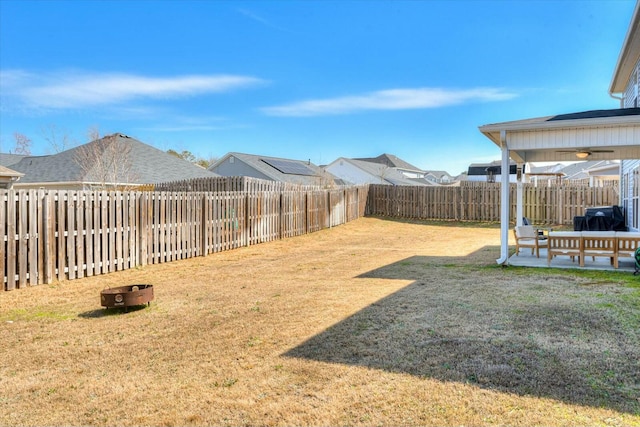 view of yard featuring a patio, a ceiling fan, and a fenced backyard