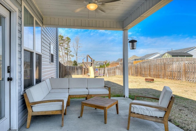 view of patio featuring an outdoor living space, a playground, a fenced backyard, and ceiling fan