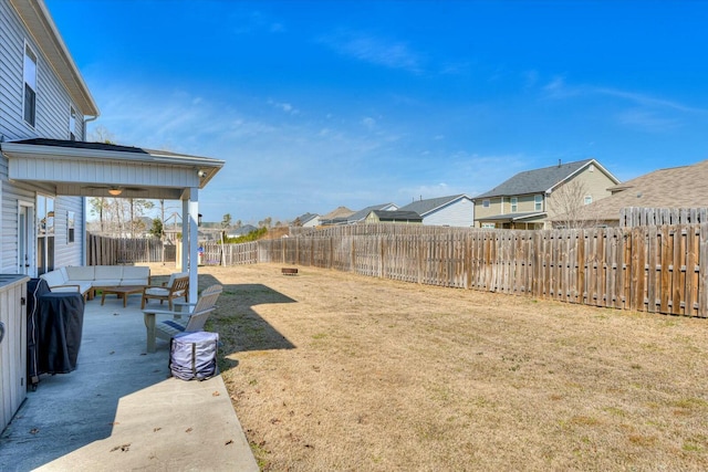 view of yard with an outdoor living space, a residential view, a patio, and a fenced backyard