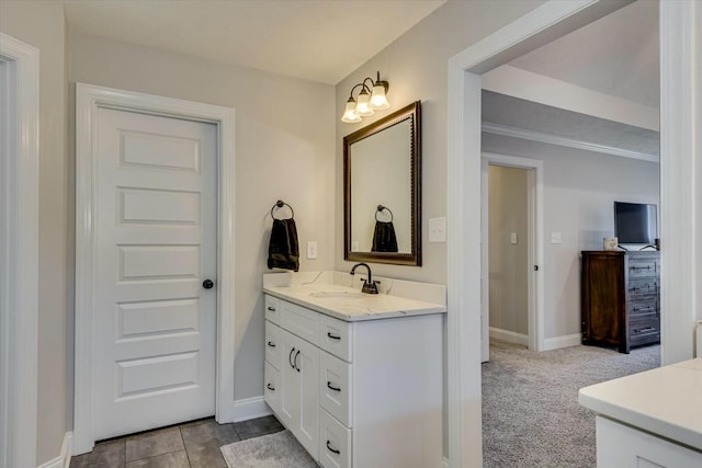 bathroom featuring tile patterned flooring, vanity, and baseboards