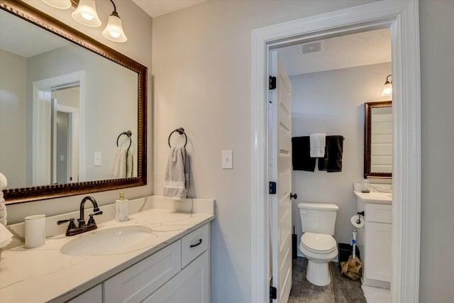 bathroom with toilet and vanity