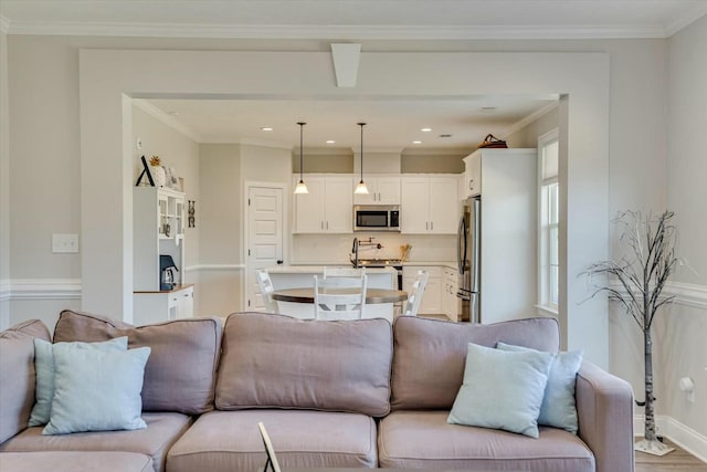 living area with recessed lighting, wood finished floors, and crown molding