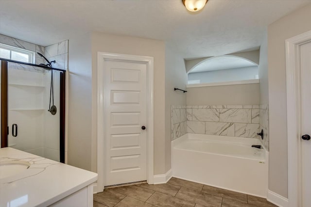 full bath featuring a shower stall, baseboards, a garden tub, tile patterned floors, and vanity