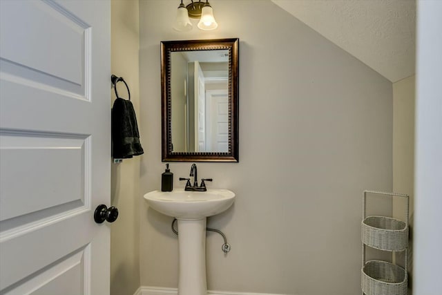 bathroom featuring vaulted ceiling