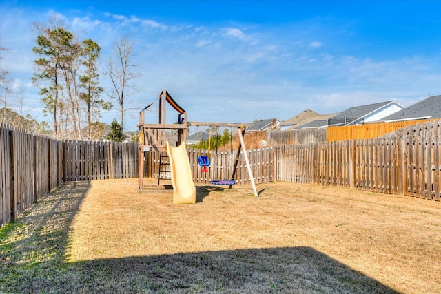 view of play area with a lawn and a fenced backyard