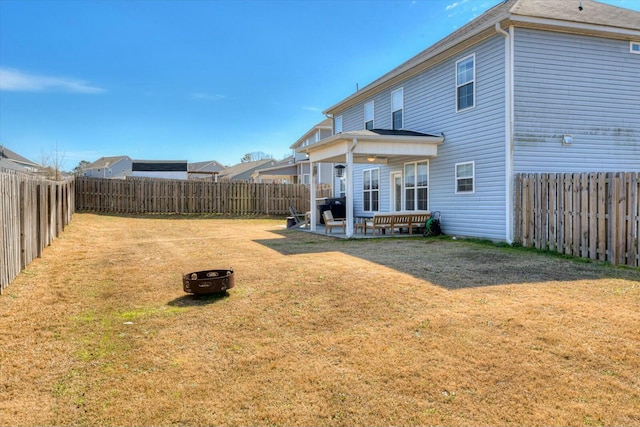 view of yard with a patio, an outdoor fire pit, and a fenced backyard