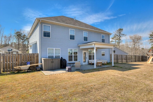 rear view of property featuring a yard, a patio, a fenced backyard, and a playground