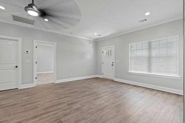 interior space with ceiling fan, crown molding, a textured ceiling, and light wood-type flooring