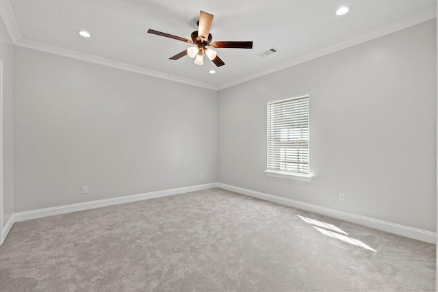 empty room featuring carpet, ceiling fan, and crown molding