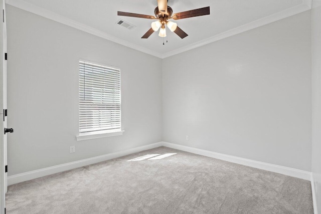 carpeted spare room featuring ceiling fan and ornamental molding