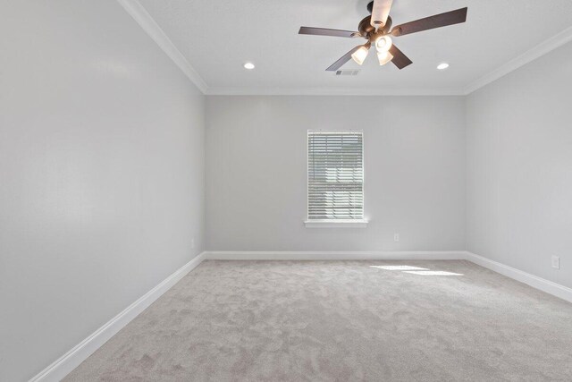 carpeted empty room featuring crown molding and ceiling fan