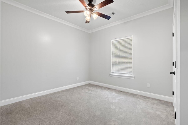 carpeted empty room with ceiling fan and ornamental molding