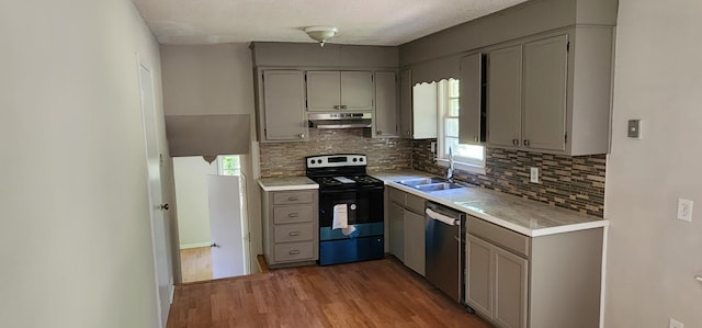 kitchen with gray cabinetry, sink, hardwood / wood-style flooring, dishwasher, and range with electric stovetop