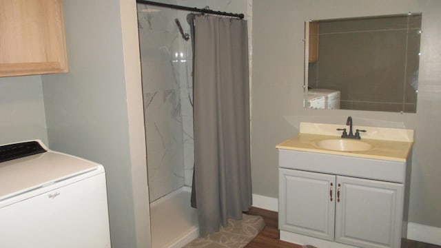 washroom featuring washer / clothes dryer, sink, and dark hardwood / wood-style flooring