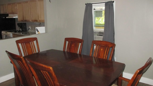 dining area with cooling unit and dark wood-type flooring