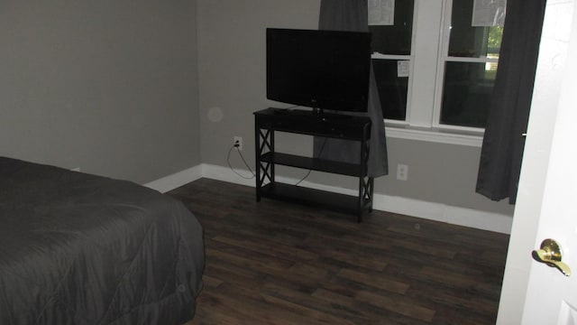 bedroom with dark wood-type flooring