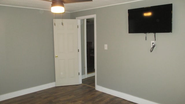 unfurnished room featuring ceiling fan and dark hardwood / wood-style floors