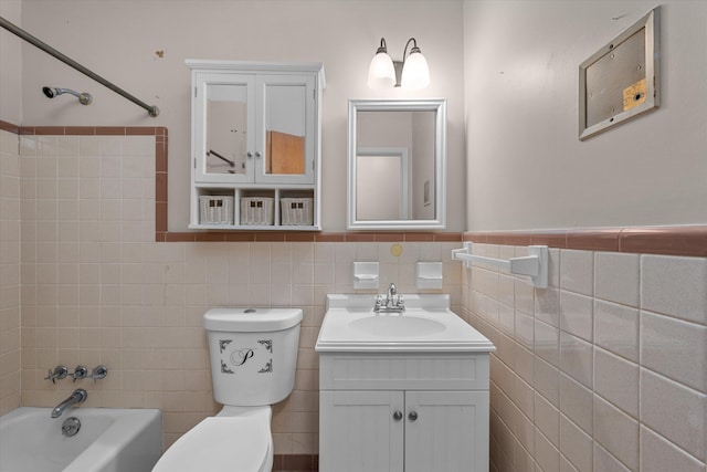 full bathroom featuring vanity, tiled shower / bath combo, toilet, and tile walls