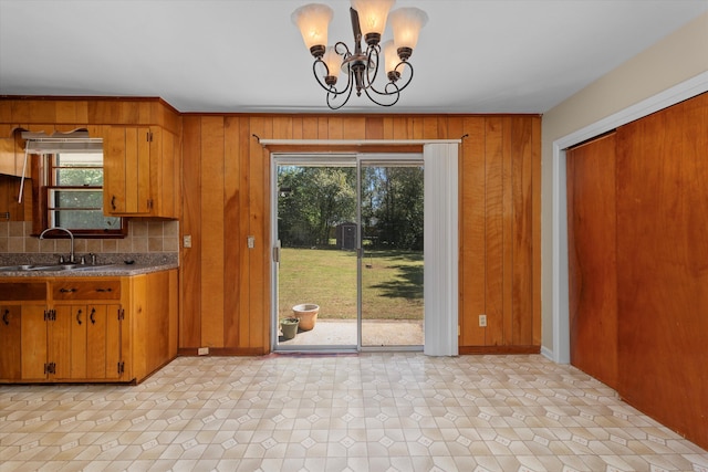 kitchen featuring a chandelier, pendant lighting, plenty of natural light, and sink