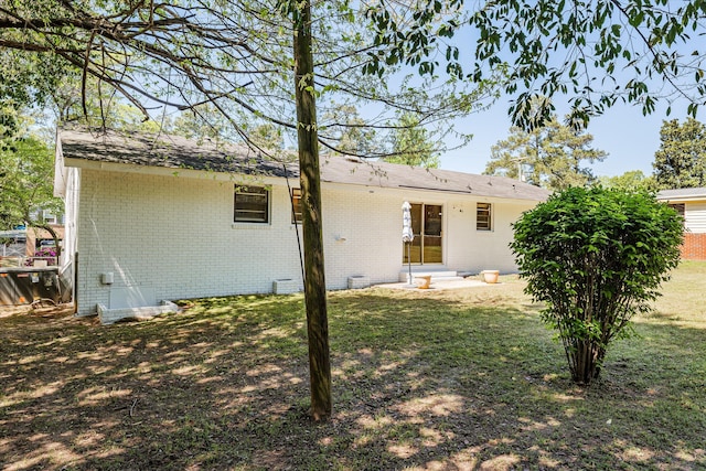 rear view of house with a yard