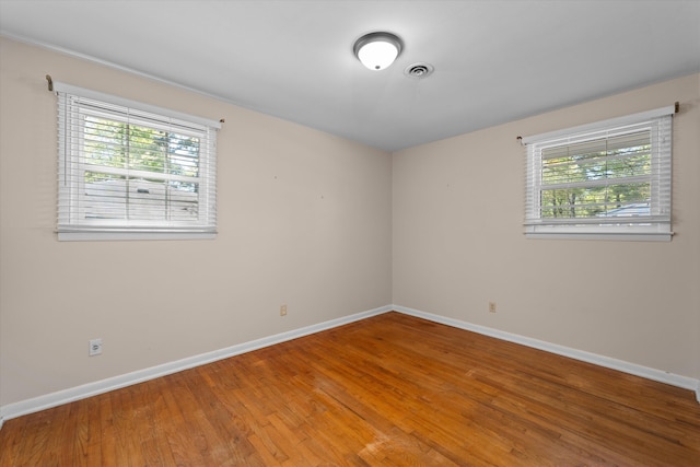 empty room with hardwood / wood-style flooring