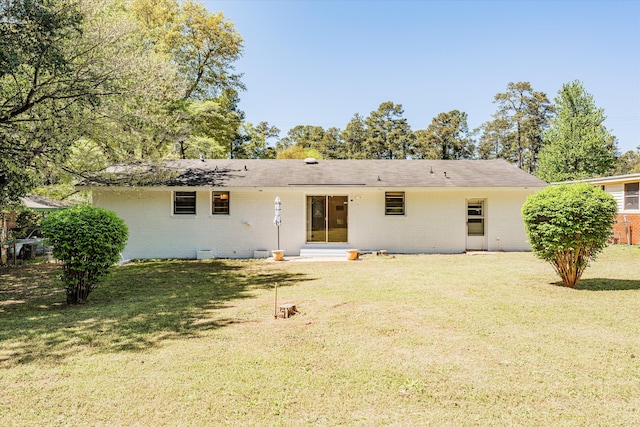 back of house with a yard