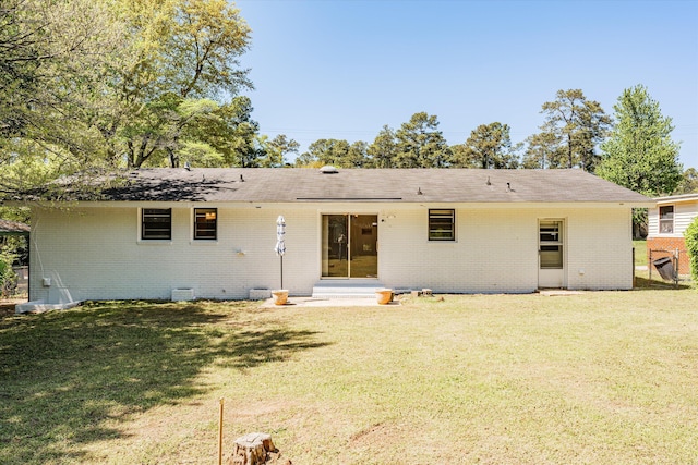 back of house featuring a yard