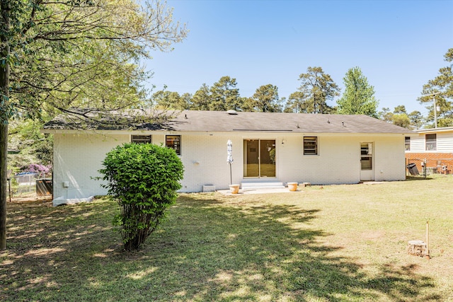 back of property featuring a lawn