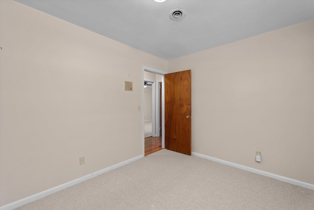 spare room with light colored carpet