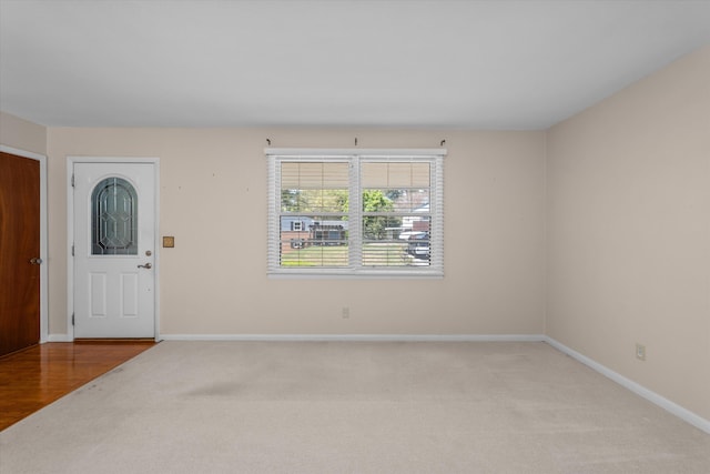 foyer entrance with light colored carpet