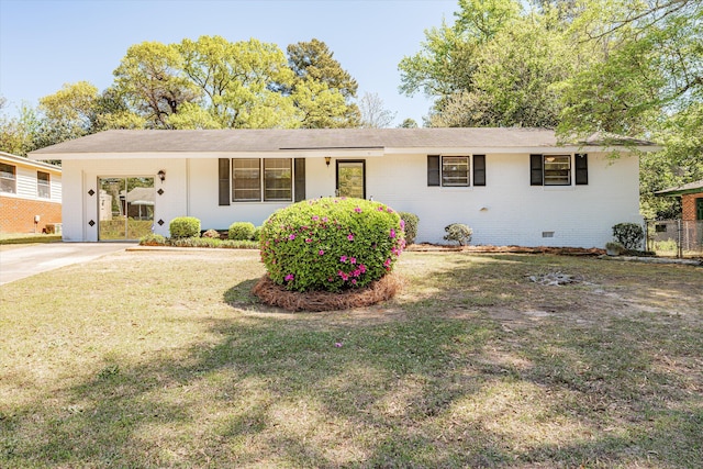 ranch-style house featuring a carport and a front lawn