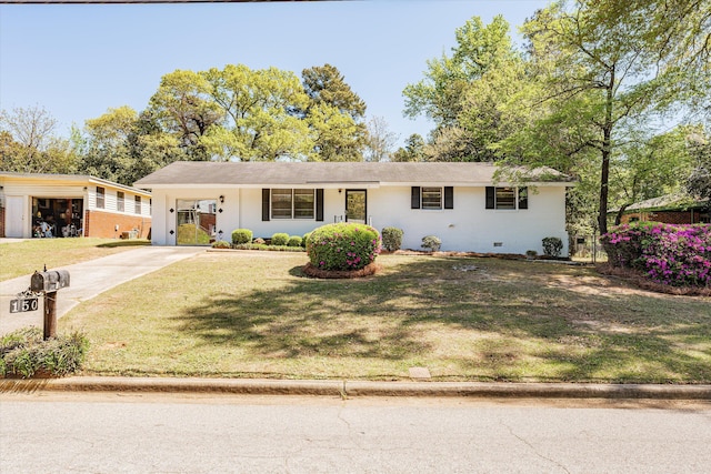 ranch-style home with a front yard and a carport